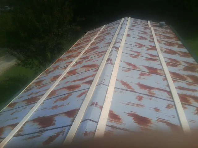 Rusted metal roof panels with new wood purlins before replacement — Storm Damage Roof Repair in Essington by Roofing Brothers