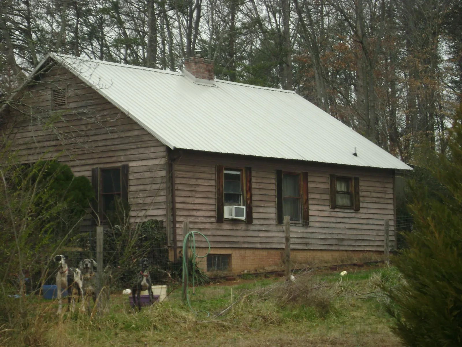 White metal roof on an old wood sided farmhouse, from a Metal Roof Installation job in Essington